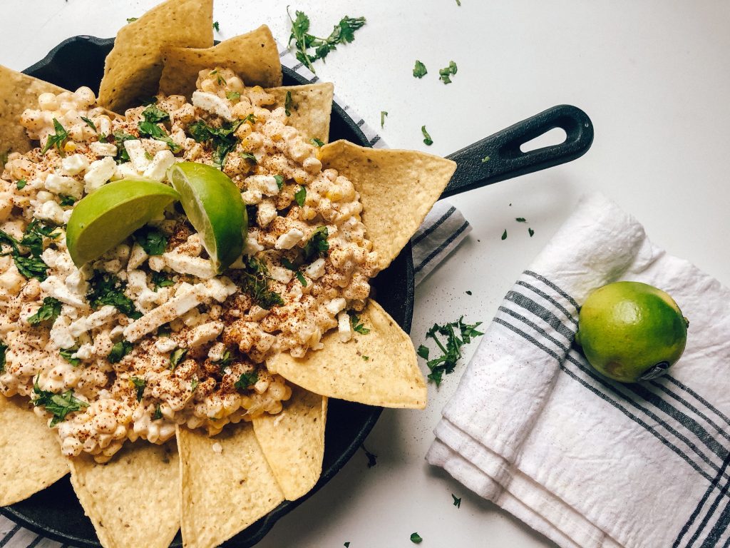 If you're a lover of nachos, I may have your new favorite dish! Mexican Street Corn Nachos, a delicious and different BBQ side dish! Check it out on my blog