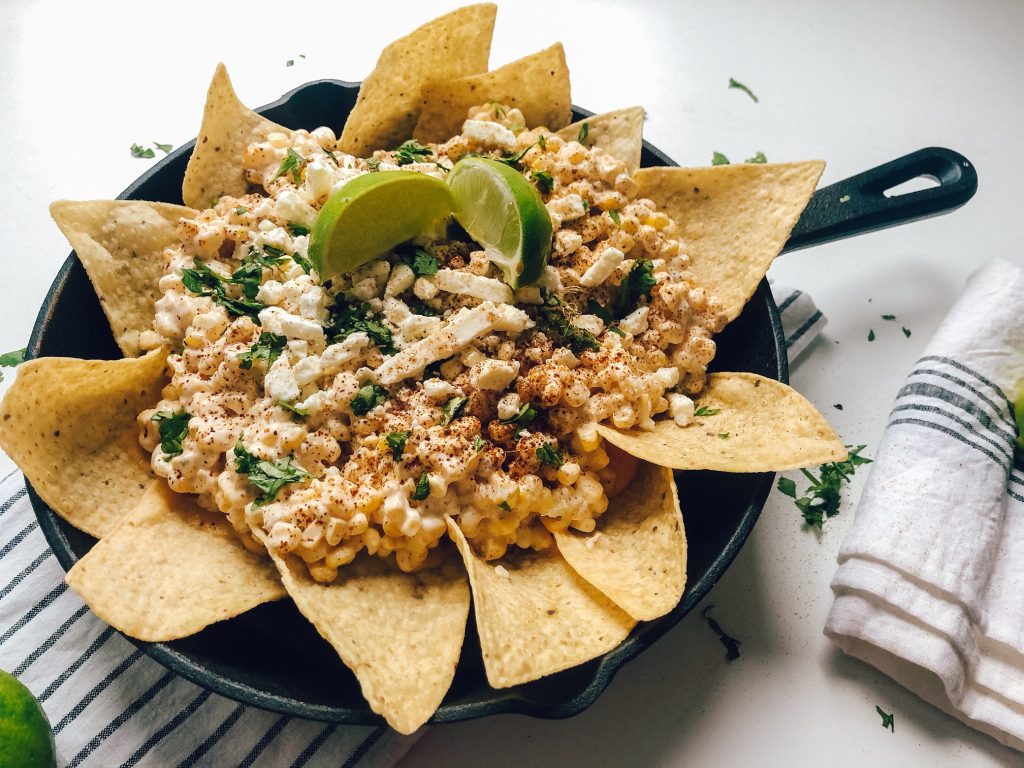 If you're a lover of nachos, I may have your new favorite dish! Mexican Street Corn Nachos, a delicious and different BBQ side dish! Check it out on my blog